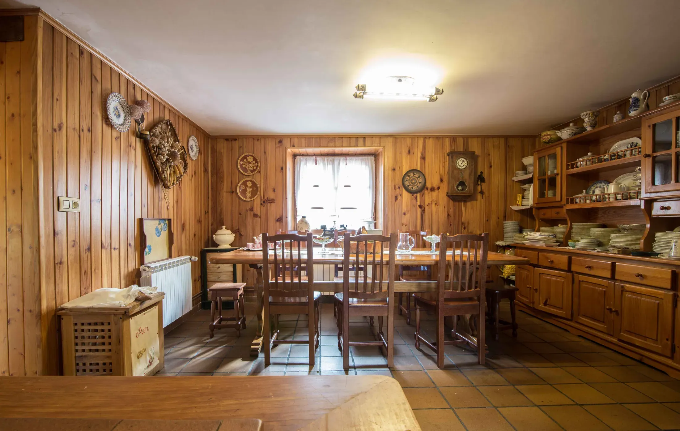 Wood-panelled dining room with a large table and sideboards
