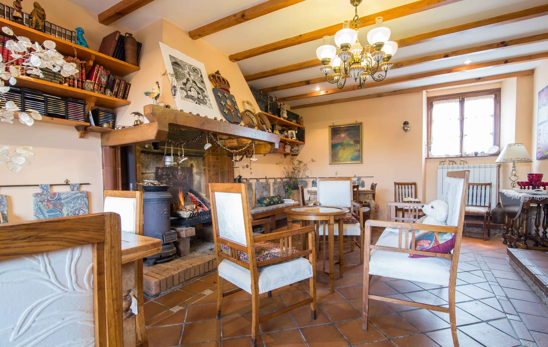 Living room with a stone fireplace, sofas and bookshelves